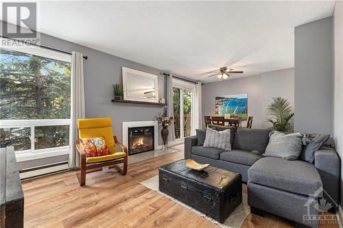 Large windows with lots of natural light - 440 Fenerty Court Unit#5, Kanata, ON - Indoor Photo Showing Living Room With Fireplace