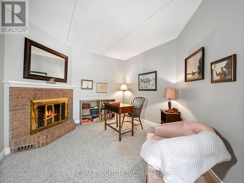 107 - 330 Brewery Lane, Orillia, ON - Indoor Photo Showing Bedroom With Fireplace