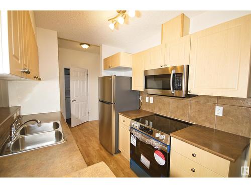 #303 5280 Terwillegar Bv Nw, Edmonton, AB - Indoor Photo Showing Kitchen With Double Sink