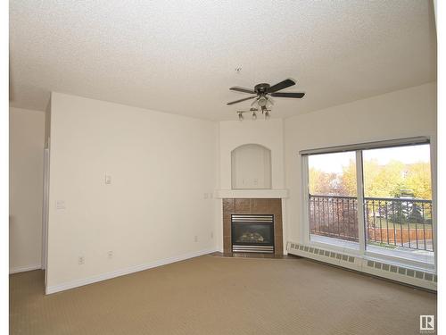 #303 5280 Terwillegar Bv Nw, Edmonton, AB - Indoor Photo Showing Living Room With Fireplace