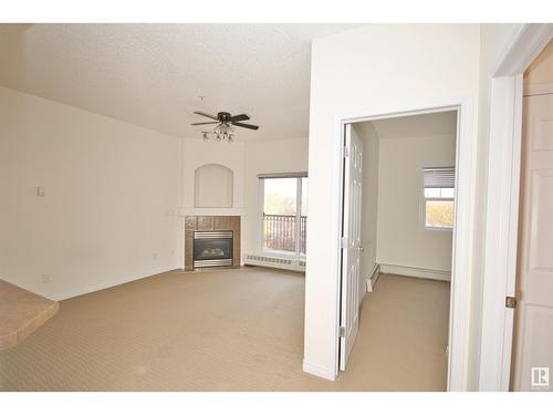 #303 5280 Terwillegar Bv Nw, Edmonton, AB - Indoor With Fireplace