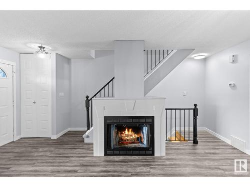 182 Tudor Ln Nw Nw, Edmonton, AB - Indoor Photo Showing Living Room With Fireplace