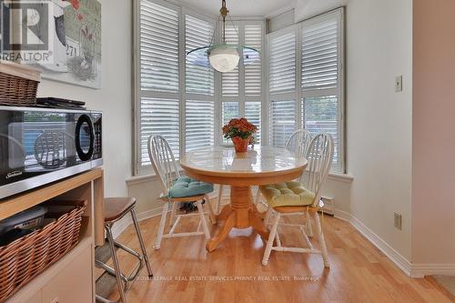 305 - 1903 Pilgrim Way, Oakville, ON - Indoor Photo Showing Dining Room With Fireplace