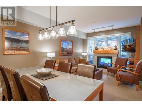 7343 Okanagan Landing Road Unit# 1121, Vernon, BC - Indoor Photo Showing Dining Room With Fireplace