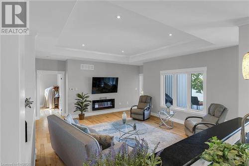 Tray ceiling - 207 Carloway Trail, Huron-Kinloss, ON - Indoor Photo Showing Living Room With Fireplace