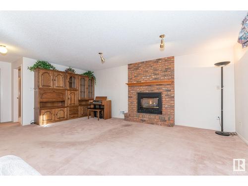 12423 56 St Nw, Edmonton, AB - Indoor Photo Showing Living Room With Fireplace