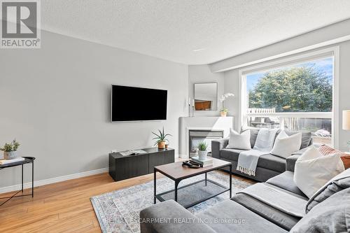 12 - 134 Terni Boulevard, Hamilton, ON - Indoor Photo Showing Living Room With Fireplace