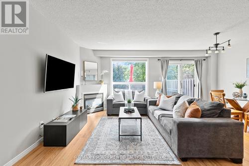 12 - 134 Terni Boulevard, Hamilton, ON - Indoor Photo Showing Living Room With Fireplace