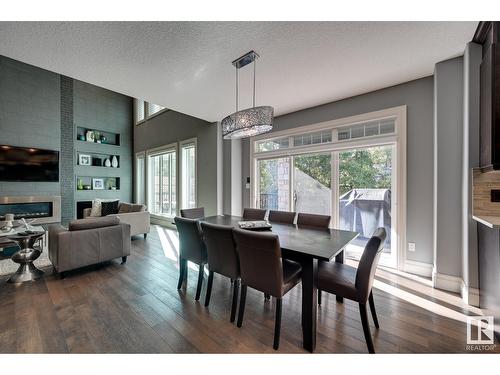 7526 May Cm Nw, Edmonton, AB - Indoor Photo Showing Dining Room With Fireplace