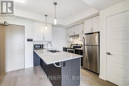 111 - 3028 Creekshore Common, Oakville, ON - Indoor Photo Showing Kitchen With Double Sink With Upgraded Kitchen