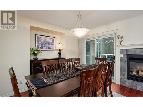 3973 Gallaghers Circle, Kelowna, BC - Indoor Photo Showing Dining Room With Fireplace