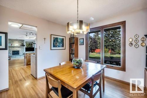 10706 33A Av Nw, Edmonton, AB - Indoor Photo Showing Dining Room With Fireplace