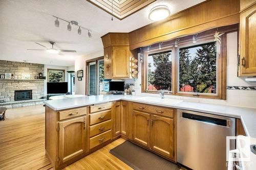 10706 33A Av Nw, Edmonton, AB - Indoor Photo Showing Kitchen With Fireplace