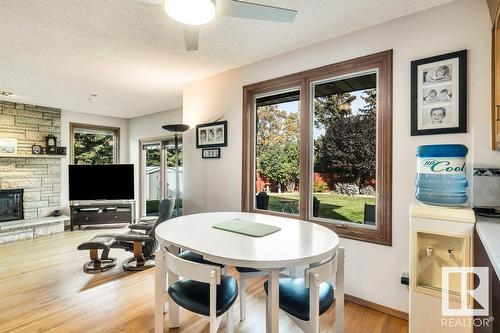 10706 33A Av Nw, Edmonton, AB - Indoor Photo Showing Dining Room With Fireplace