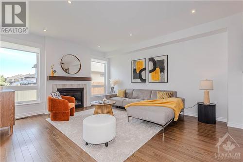 Expansive Great Room complemented by cozy gas fireplace - 600 Triangle Street, Ottawa, ON - Indoor Photo Showing Living Room With Fireplace