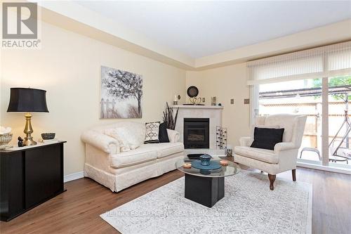 32 - 2025 Cleaver Avenue, Burlington, ON - Indoor Photo Showing Living Room With Fireplace