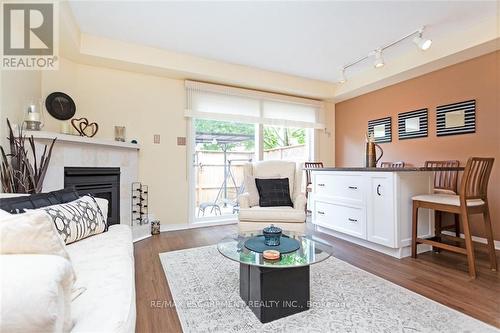 32 - 2025 Cleaver Avenue, Burlington, ON - Indoor Photo Showing Living Room With Fireplace