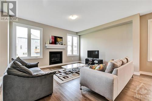 210 Kimpton Drive, Stittsville, ON - Indoor Photo Showing Living Room With Fireplace