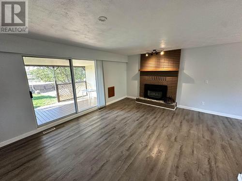 718 Cariboo Trail, 100 Mile House, BC - Indoor Photo Showing Other Room With Fireplace