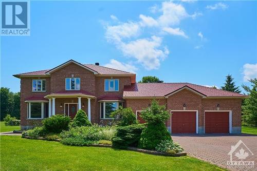 Full brick exterior & expanded driveway & high-quality metal roof - 42 Marchbrook Circle, Kanata, ON - Outdoor With Facade