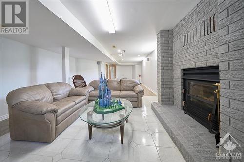 Living room in the basement with 2nd fireplace - 42 Marchbrook Circle, Kanata, ON - Indoor Photo Showing Living Room With Fireplace