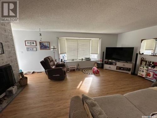 303 Dominion Bay, Central Butte, SK - Indoor Photo Showing Living Room With Fireplace