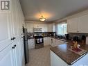 303 Dominion Bay, Central Butte, SK  - Indoor Photo Showing Kitchen With Double Sink 