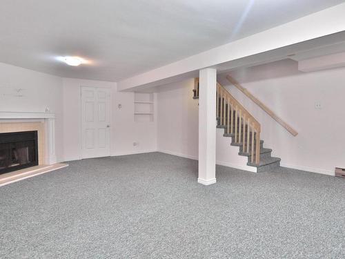 Basement - 239 Rue Blue Haven, Dollard-Des-Ormeaux, QC - Indoor With Fireplace