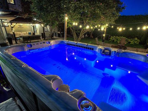 Spa - 772 Rue Galbrand, Laval (Sainte-Dorothée), QC - Outdoor With Above Ground Pool With Backyard