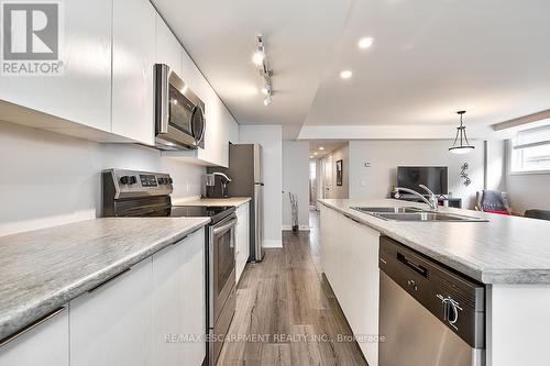 101 - 3058 Sixth Line, Oakville, ON - Indoor Photo Showing Kitchen With Double Sink