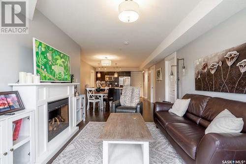 117 5301 Universal Crescent, Regina, SK - Indoor Photo Showing Living Room With Fireplace