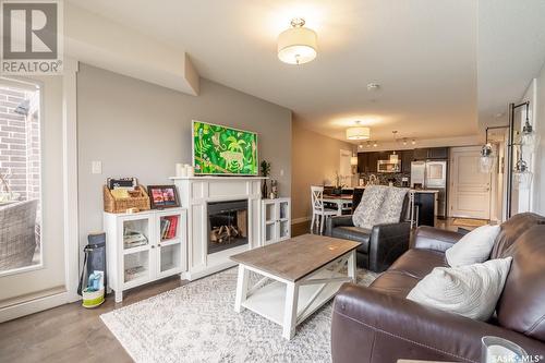 117 5301 Universal Crescent, Regina, SK - Indoor Photo Showing Living Room With Fireplace