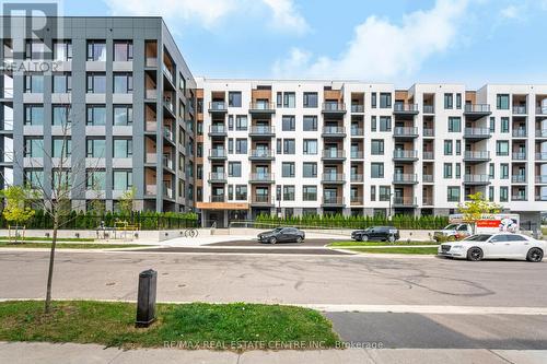 210 - 1440 Clarriage Court, Milton, ON - Outdoor With Balcony With Facade