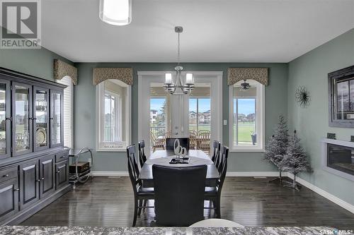 4224 Green Rose Crescent E, Regina, SK - Indoor Photo Showing Dining Room With Fireplace