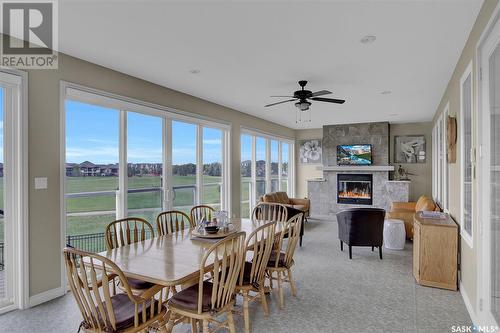 4224 Green Rose Crescent E, Regina, SK - Indoor Photo Showing Dining Room With Fireplace