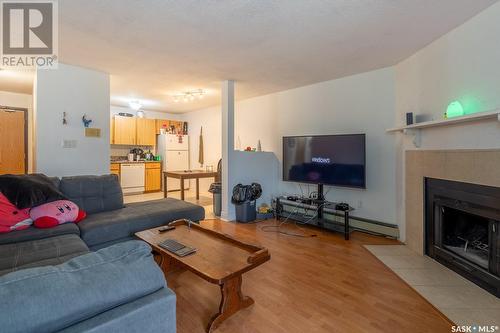 417 2410 Heseltine Road, Regina, SK - Indoor Photo Showing Living Room With Fireplace