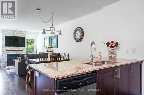 202 - 4 Brandy Lane Drive, Collingwood, ON - Indoor Photo Showing Kitchen With Fireplace With Double Sink