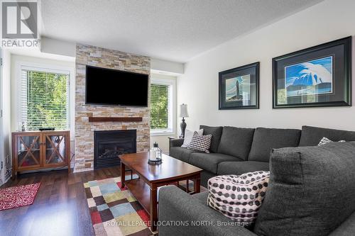 202 - 4 Brandy Lane Drive, Collingwood, ON - Indoor Photo Showing Living Room With Fireplace