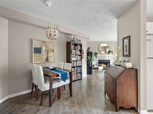 410-2520 Wark St, Victoria, BC - Indoor Photo Showing Dining Room With Fireplace