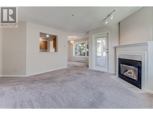 3320 Centennial Drive Unit# 209, Vernon, BC - Indoor Photo Showing Living Room With Fireplace