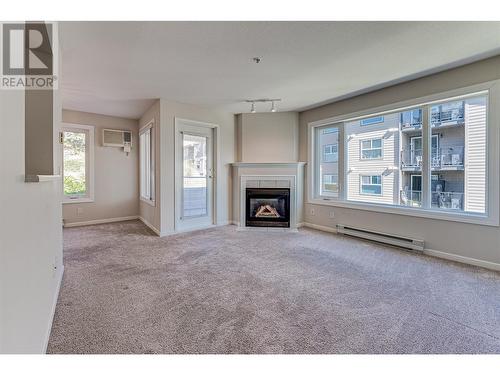 3320 Centennial Drive Unit# 209, Vernon, BC - Indoor Photo Showing Living Room With Fireplace