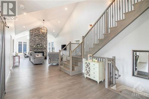 209 Des Violettes Street, Hammond, ON - Indoor Photo Showing Other Room With Fireplace