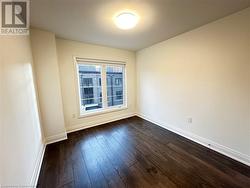 Spare room with dark hardwood / wood-style floors - 