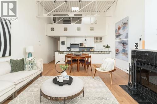 210 - 99 Coleman Avenue, Toronto, ON - Indoor Photo Showing Living Room With Fireplace