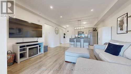 512 - 4 Spice Way, Barrie, ON - Indoor Photo Showing Living Room With Fireplace