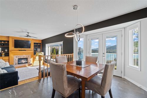 7901 Kalview Drive, Coldstream, BC - Indoor Photo Showing Dining Room With Fireplace