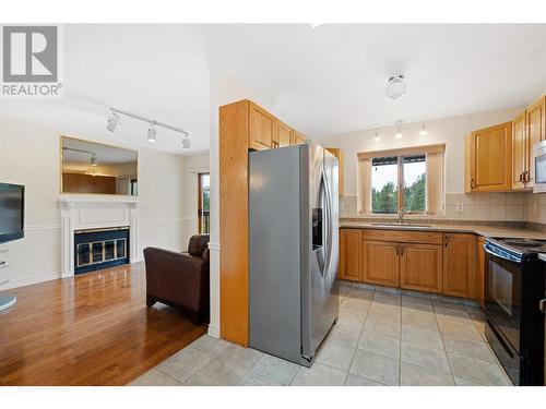 775 Cassiar Court, Kelowna, BC - Indoor Photo Showing Kitchen With Fireplace