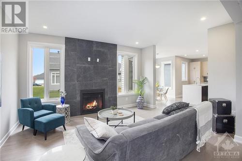 Floor-to-ceiling fireplace surround - 348 Ventoux Avenue, Ottawa, ON - Indoor Photo Showing Living Room With Fireplace