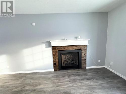 10681 Cottonwood Cresent, Dawson Creek, BC - Indoor Photo Showing Living Room With Fireplace