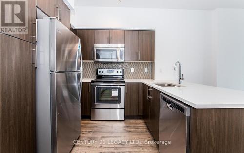 1606 - 65 Speers Road, Oakville, ON - Indoor Photo Showing Kitchen With Stainless Steel Kitchen With Double Sink